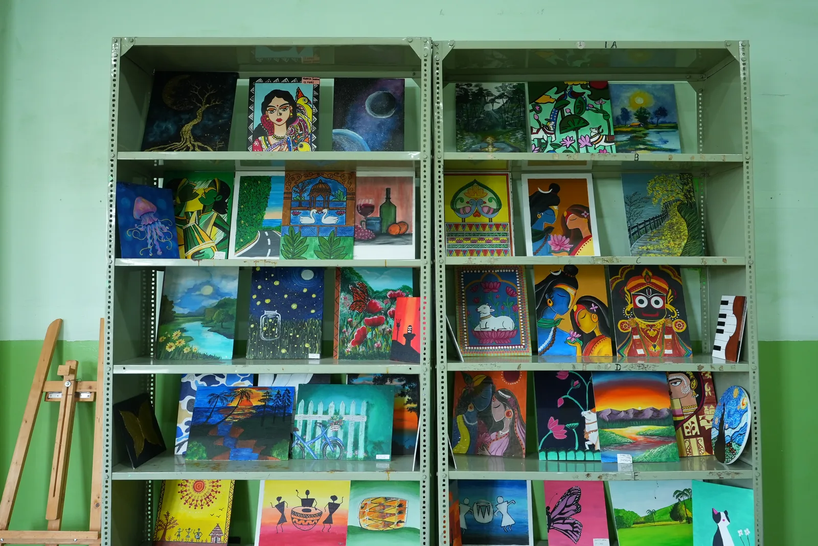 Student paintings on metal racks